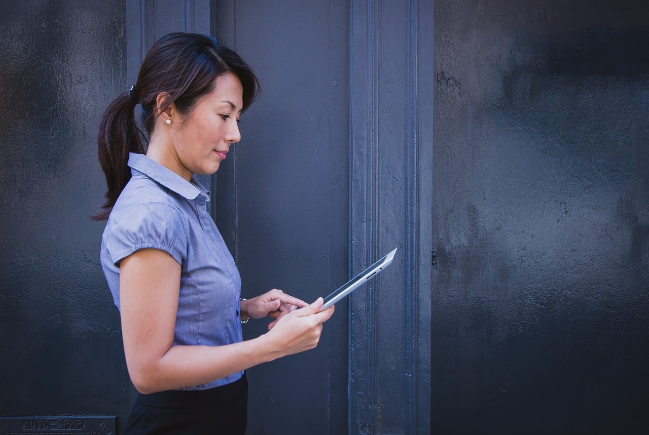 Business woman with a tablet working on quality control and team management.
