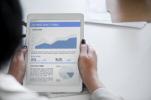 Business woman looking at a business growth goals chart on a tablet